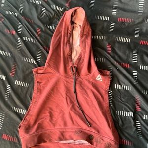 This is a cropped Reebok workout hoodie in the colour burgundy